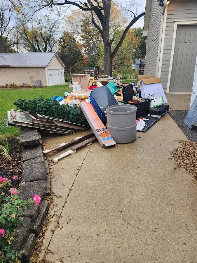 Dumpster being loaded with debris for Estate Cleanout Dumpster Rental in Natchez
